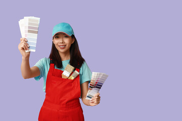 Wall Mural - female asian painter with brushes and paint color palettes on purple background