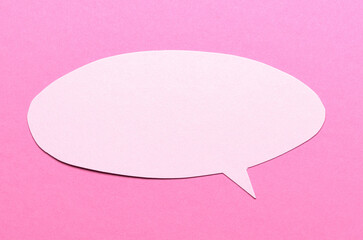 Poster - Blank paper speech bubble of round shape with copy space for text on pink background, flat lay top view conceptual backdrop