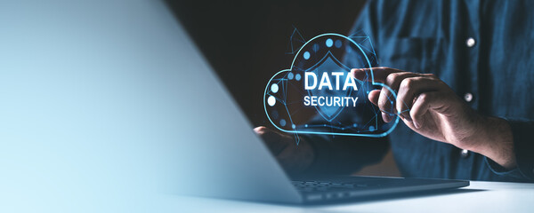 Poster - data security concept with a holographic cloud shield displayed above a laptop.