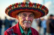 © IRINA - Cinco de Mayo is a holiday created by Latin American communities and celebrated by Mexican Americans. An elderly man in a beautiful multi colored Mexican hat.