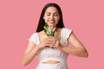 Sticker - Beautiful young happy woman with lily-of-the-valley flowers on pink background