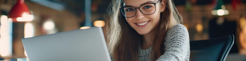 Poster - A woman wearing glasses works on her laptop at home