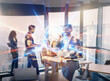 © YiuCheung - Abstract double exposure image depicting a sci-fi business scene.  A businessman interacts with glowing digital currency symbols against a cityscape background, colleagues blurred in the foreground.
