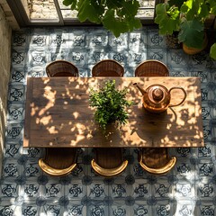 Fototapete - Overhead shot capturing oak wooden table with chairs and a copper watering can placed on the side highlighting the intricate patterns of the modern floor in a peaceful orangery
