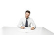© peshkova - Man in formal attire writing on paper, seated at a desk. Isolated on a clean white background. Concept of office work, signing documents