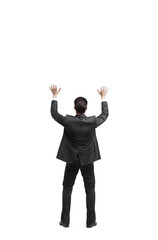 Poster - Man in a suit seen from behind, raising arms in celebration or surrender, isolated on a white background. Concept of success or gesture