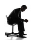 © peshkova - Silhouette of a man in a suit sitting on a chair, leaning forward with clasped hands in a contemplative pose, isolated on a white background