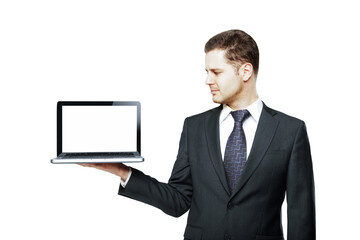 Poster - A businessman in a suit holding a laptop with a blank screen, isolated on a white background. Concept of technology, templates, and online design