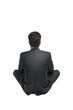 © peshkova - Rear view of a man in a formal dark suit sitting cross-legged, isolated on a clean white background. Concept of professionalism and contemplation