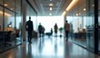 © MDJEWEL - blurred office hallway, silhouettes of business people walking, modern corporate interior, glass walls, reflective floor, overhead lighting, professional environment, out of focus background,