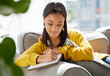 © Nina Lawrenson/peopleimages.com - Woman, relax and writing in journal at house for diary entry, personal growth and wellness affirmations. Female person, book and creativity for goals reminder, inspiration quotes and gratitude letter