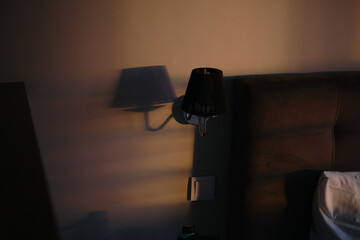 Lamp on a night table next to a bed