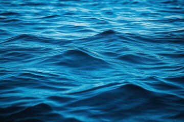 Poster - Vast Tranquil Blue Ocean Waves Gently Lapping Against Soft Sandy Shore Under Clear Blue Sky Evoking Calmness and Natural Beauty in Coastal Scene