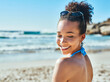 © peopleimages.com - Beach, happy and woman in summer by ocean in bikini for vacation, travel and holiday on tropical island. Relax, nature and person with waves, water and seaside for adventure, weekend and getaway