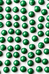 Wall Mural - Close-up of glossy green candies arranged in a uniform pattern