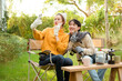 © tonefotografia - Two Friends Enjoying a Cozy Outdoor Moment While Taking a Selfie in a Sunny Garden