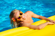 © Sunny studio - Happy young woman having fun in swimming pool on summer vacation