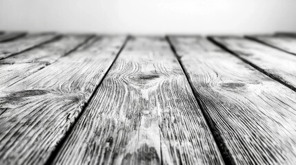 Wall Mural -  a black and white photo of a wooden table with a white background The table is made of wood planks, giving it a rustic and natural look