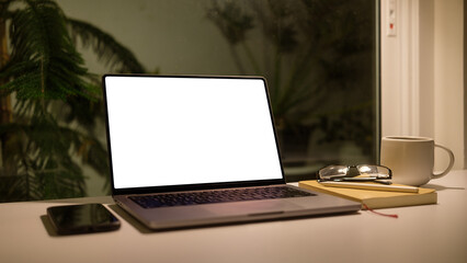 Fototapete - Serene workspace with laptop, a cup of coffee and notebook.