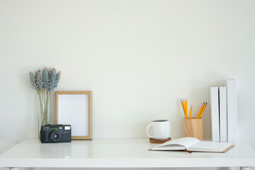 Wall Mural - Simple workspace retro camera and lavender flowers, notebook, coffee mug and writing supplies.
