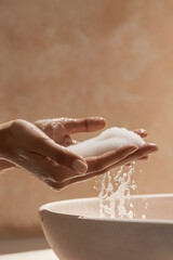 Gentle cleansing foam creates a luxurious lather in hands, then rinsing into a basin.