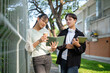 © wattana - Happy college friends standing outdoors near a campus building. Education concept.