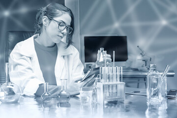 Poster - Woman microbiologist. Girl biologist in laboratory. Scientist with test tubes and e-tablet. Microbiologist examines liquids in flasks. Woman laboratory assistant at workplace. Monochrome portrait