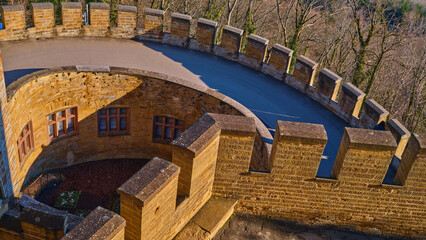 A scenic view from a castle turret, surrounded by trees, invites you to appreciate the beauty of nature while reflecting on the historical architecture enduring through time.