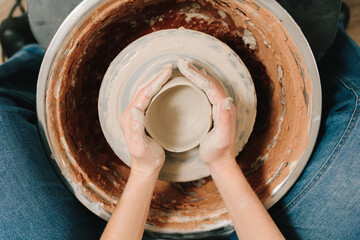 Fototapete - Process of making a unique ceramic shape. Potter creates a ceramic bowl in the pottery studio.