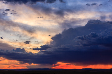Wall Mural - the sky is filled with clouds and the sun is setting
