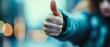 © Ps_Studio21 - A person giving a thumbs up sign in approval.