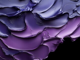 Colorful layers of paint creating an abstract texture with rich purple and blue hues displayed against a black background