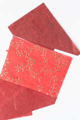 Wall Mural - samples of soft, textured red paper with floral motif on a white background