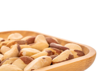 Wall Mural - Brazil nuts without shells on a bamboo tray, macro, on a white background.