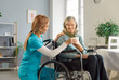 © Studio Romantic - Caring female doctor or nurse bringing tea to a senior woman patient sitting in a wheelchair at a nursing home. Providing care, comfort, and support in a warm and compassionate environment.