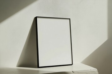 Poster - Minimalistic black picture frame presented in serene white surroundings for artistic expression