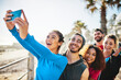 © peopleimages.com - Fitness team, selfie and happy people outdoor to post picture for wellness, health and excited on social media. Exercise group, friends and photo together for memory, sports and training at beach