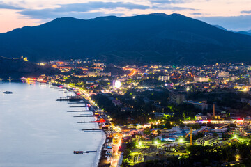 Wall Mural - Beautiful view of the night embankment of the city of Sudak after sunset. South coast of the Crimean peninsula. Russia