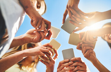 Poster - People, hands and below with phone for data sync, communication or network under blue sky. Low angle, closeup or group with mobile smartphone for connectivity, social media or global software app
