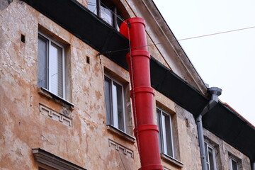 Aufkleber - A red fire hydrant on the side of a building, suitable for urban or cityscape scenes.