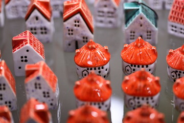 Poster - Miniature ceramic houses on a wooden table.