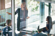 © ArcursCoop/peopleimages.com - Business woman, presentation and charts in boardroom with group for b2b strategy, speech and monitor. Person, speaker and information with graphs, screen and sales with meeting for brand identity