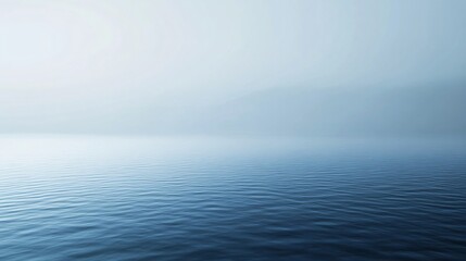 Wall Mural - Minimalist landscape showing a light blue water surface merging with fog in a misty day