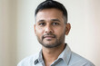 © PixPacks - Young businessman. Head shot portrait profile picture at social media handsome bearded casual millennial man posing at home or in work office looking at camera feeling serious ambitious self confident