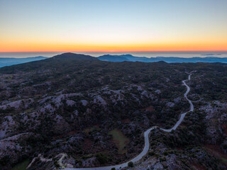 Wall Mural - Winding mountain road at sunset