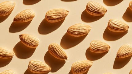 Poster - A vibrant shot of whole almonds on a neutral background, showcasing the glossy finish and fine details of their brown, textured skin