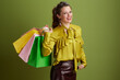 © Alliance - happy trendy woman in green blouse isolated on green background