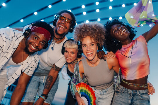 happy friends listening music at silent disco outdoor party