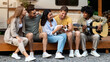 © Prostock-studio - Funky young diverse friends with pet dog and guitar playing music, having fun, relaxing near RV on autumn weekend, camping together in countryside. Fall season tourism concept