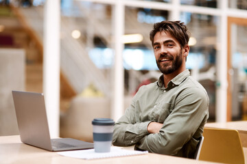 Poster - Portrait, smile and business man with arms folded in office for career pride, creative and startup experience. Face, happy professional and employee, copywriter or confident worker with laptop in USA